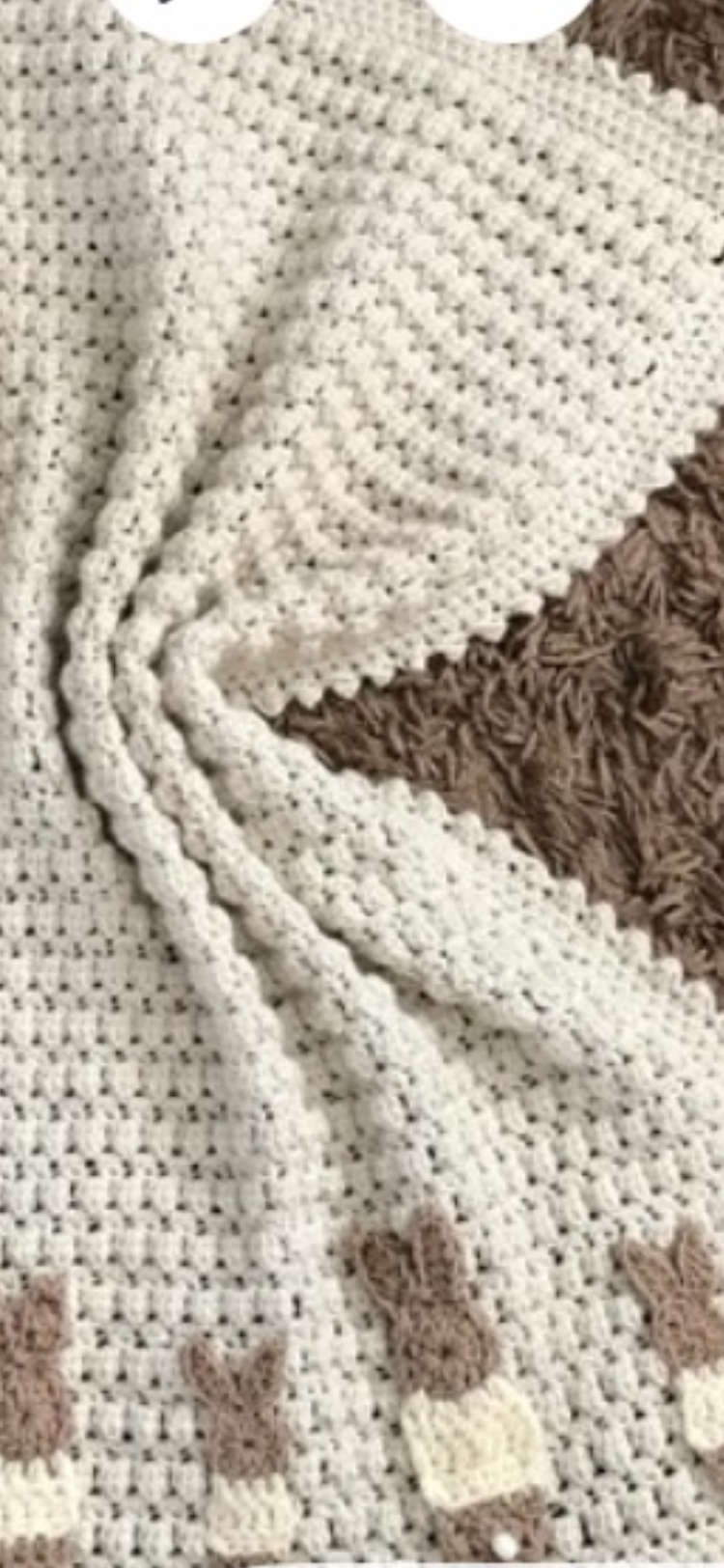 Crochet blanket with bright pink and black ladybug square motifs